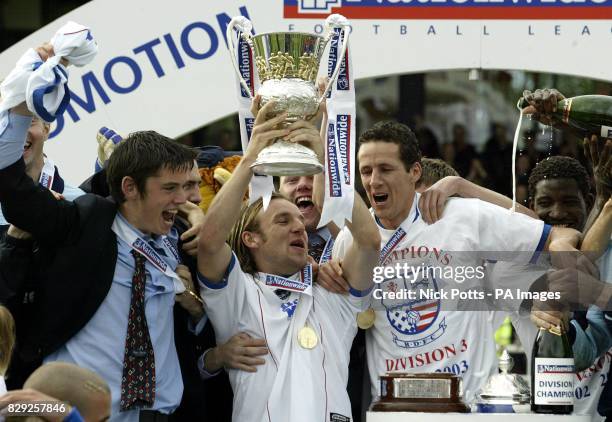 Rushden & Diamonds' captain Paul Underwood lifts the Divison Three trophy with Barry Hunter after drawing with Hartlepool United to take the title,...