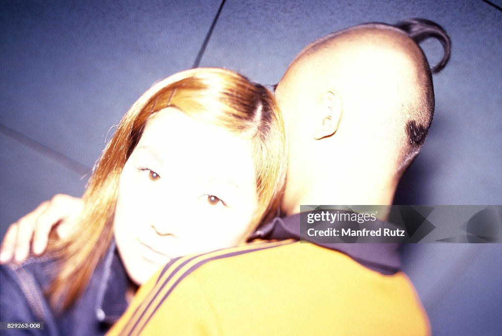 Young couple embracing, close-up