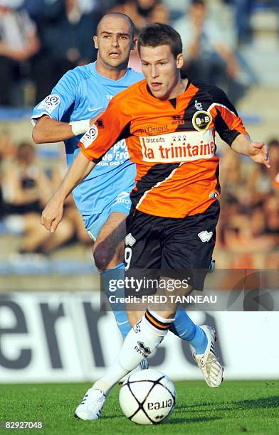 Caen's midfielder Benjamin Nivet vies withs Lorient's forward Kevin Gameiro during the French L1 football match Lorient vs. Caen, on September 20,...