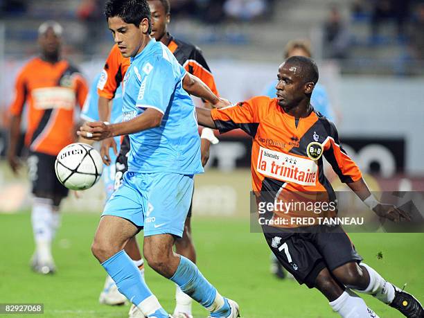Caen's defender Pablo Barzola vies with Lorient's midfielder Oscar Ewolo during the French L1 football match Lorient vs. Caen, on September 20, 2008...