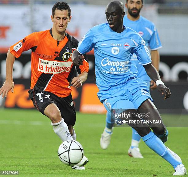 Caen's midfielder Remi Gomis and Lorient's forward Rafik Saïfi fight for the ball during the French L1 football match Lorient vs. Caen, on September...