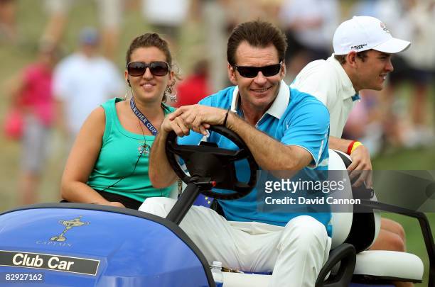 European team captain Nick Faldo rides with his daughter Natalie and son Matthew on the first tee during the afternoon four-ball matches on day two...