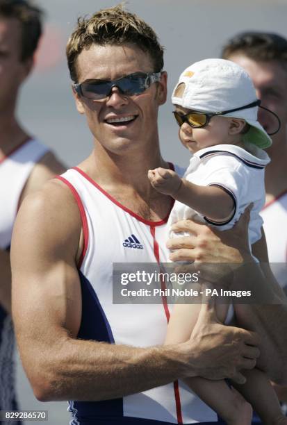 British rower James Cracknell with his baby son Croyde following his Olympic win in the Men's Four rowing final during the 2004 Olympic Games at the...