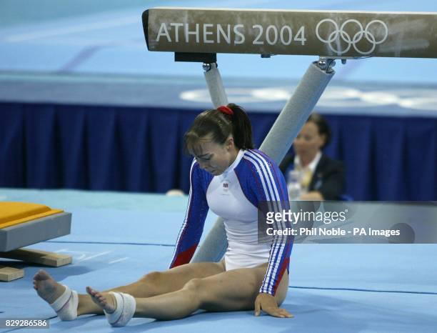 British gymnast Beth Tweddle sits on the floor after falling off the beam during the Women's Individual Artistic Gymnastics final at the Olympic...