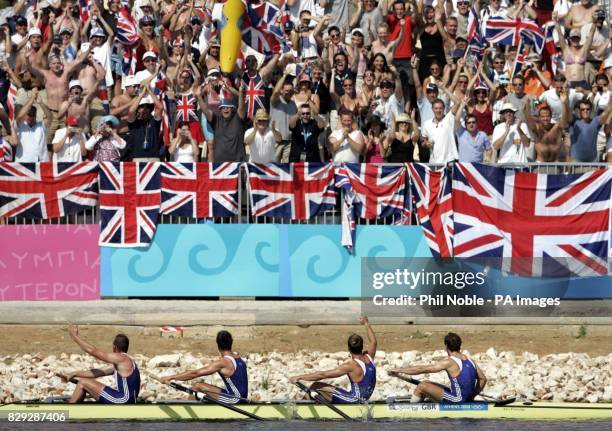 Great Britain's Men's four rowing team wave to British supporters after winning Olympic Gold medals during the 2004 Olympic Games at the Schinias...
