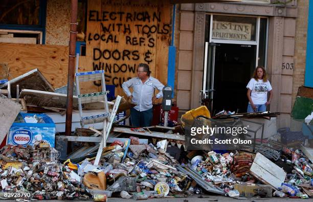 Residents of the Justine Apartments stand near a pile of rotting food outside their front door September 20, 2008 in Galveston, Texas. The food was...
