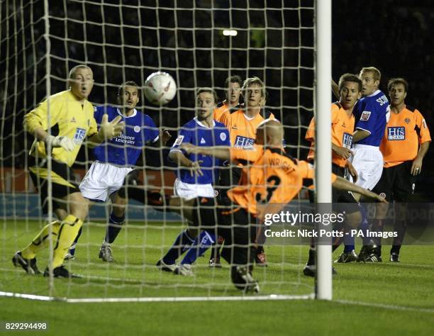 Leicester City's Nikos Dabizas watches his header go past Sheffield United goalkeeper Paddy Kenny and defender Alan Wright , to score Leicester's 2nd...