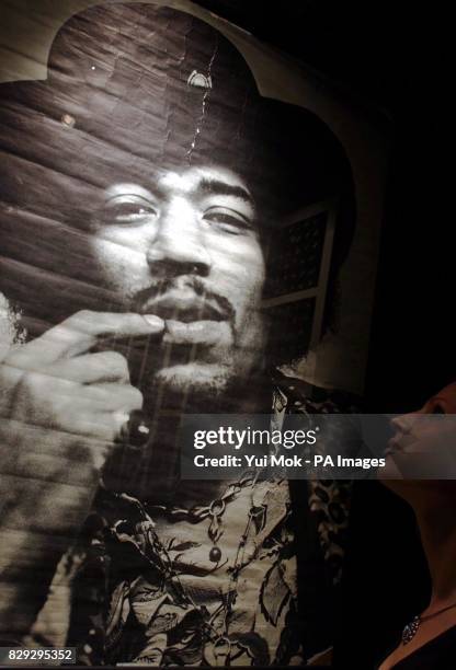 Visitor studies a poster on display at the press preview for the exhibition Jimi At The Marquee, featuring the world's largest collection of Jimi...