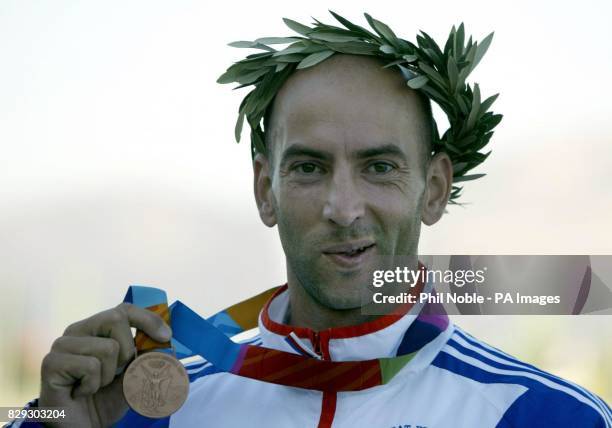 Great Britain's Ian Wynne from Tonbridge celebrates after winning a bronze medal in the Kayak Flatwater Racing K1 500m class at the Schinias Olympic...