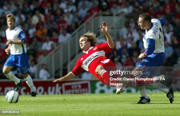 Middlesbrough's Bolo Zenden battles with Crystal Palace's Michael Hughes during their Barclays Premiership match at the Riverside Stadium,...