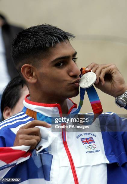 British Olympic silver medal winning boxer Amir Khan, kisses his medal, during the open-top bus tour of his home town of Bolton. Olympic silver...