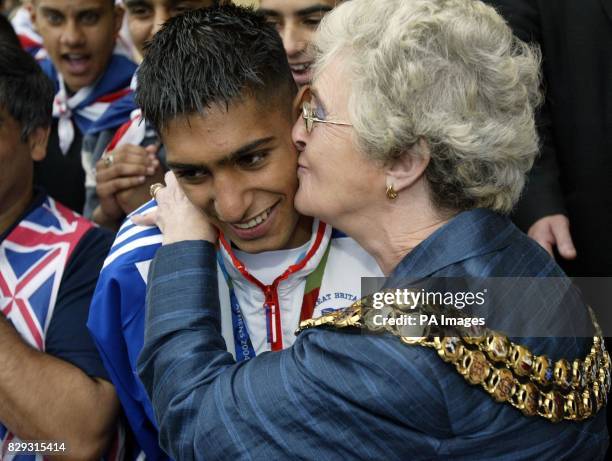 Olympic boxer Amir Khan receives a kiss from the Mayor of Bolton, Councillor Howarth, as he celebrates winning a silver medal on the steps of Bolton...