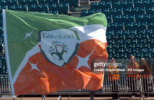 Stewards look at a flag printed with the new Football Association of Ireland logo, before the World Cup European Qualifying Group Four match, at...