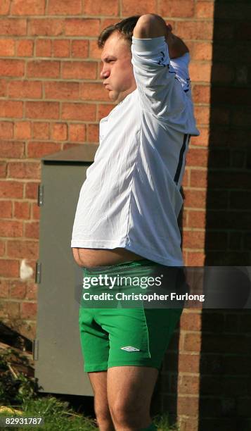 Schools secretary Ed Balls takes warms up before taking part in the traditional football match between politicians and journalists during the Labour...