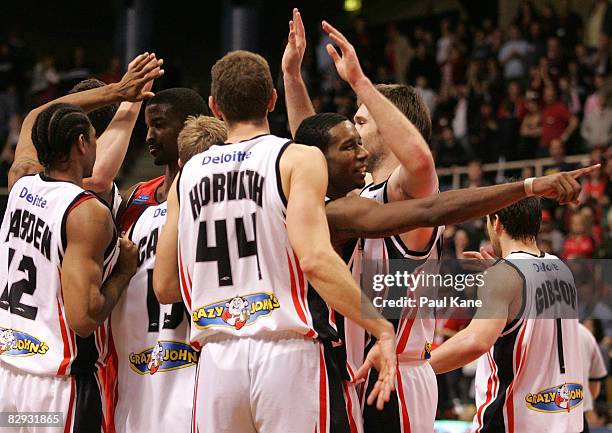 Cortez Groves of the Dragons gestures to the crowd as team mates celebrate winning the NBL round one match between the Perth Wildcats and the South...