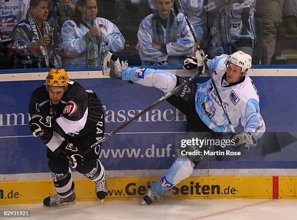 Sebastian Osterloh of Frankfurt tackles Marcus Sommerfeld of Hamburg at the board during the DEL match between Hamburg Freezers and Frankfurt Lions...