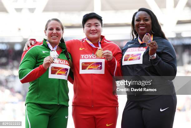 Anita Marton of Hungary, silver, Lijiao Gong of China, gold, and Michelle Carter of the United States, bronze, pose with their medals for the Women's...
