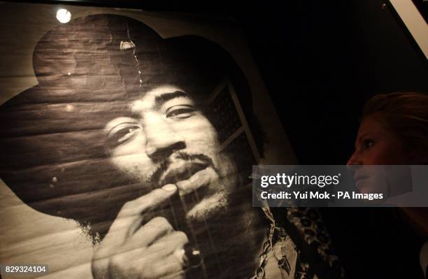 Visitor studies a poster on display at the press preview for the exhibition Jimi At The Marquee, featuring the world's largest collection of Jimi...