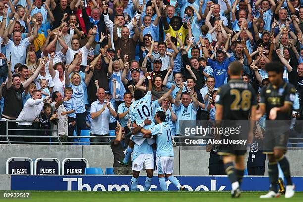 Jo of Manchester City is mobbed by Robinho and his team mates after scoring the opening goal during the Barclays Premier League match between...