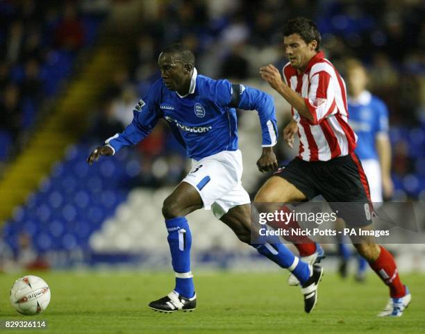 Birmingham City's Dwight Yorke shields the ball away from Lincoln City's Richard Butcher during their Carling Cup second round match at St Andrews,...