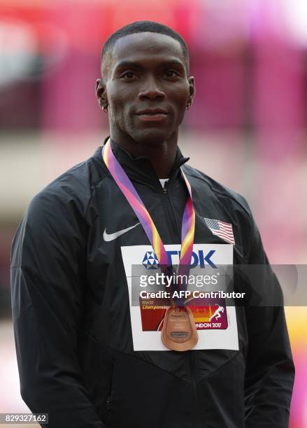 Bronze medallist US athlete Kerron Clement poses on the podium during the victory ceremony for the men's 400m hurdles athletics event at the 2017...