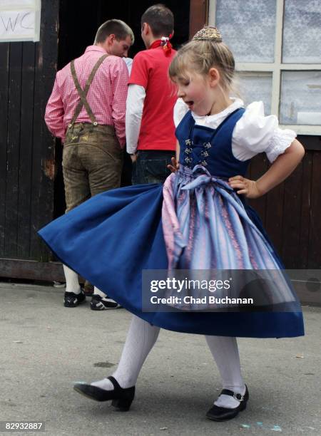 Young girl in a traditional Germany dirndl dances during day 2 of the Oktoberfest beer festival on September 21, 2008 in Munich, Germany. The...