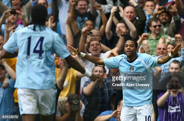Robinho of Manchester City celebrates scoring his team's third goal with team mate Jo during the Barclays Premier League match between Manchester...