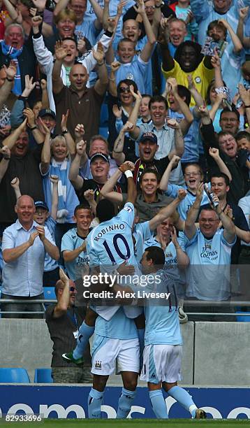 Jo of Manchester City is mobbed by Robinho and his team mates after scoring the opening goal during the Barclays Premier League match between...