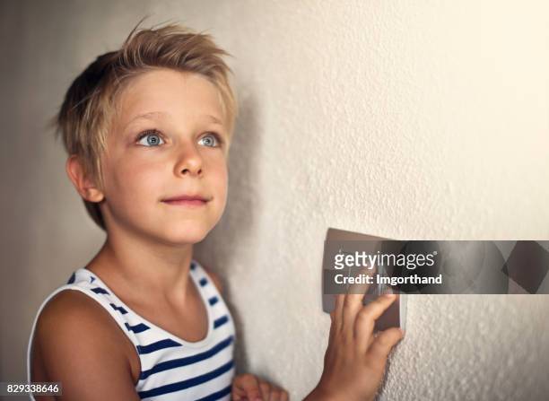 little boy turning on light - play off stock pictures, royalty-free photos & images