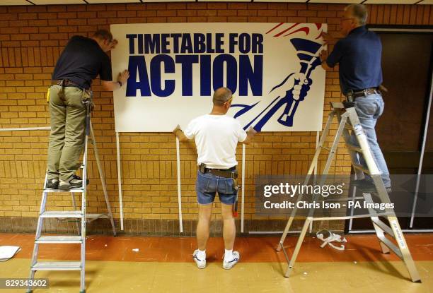 Sign writers erect placards at the Bournemouth International Centre, in preparation for the Conservative Party's annual conference which starts...