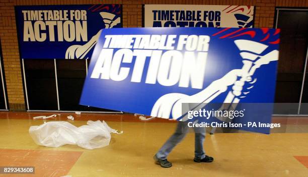 Sign writers erect placards at the Bournemouth International Centre, in preparation for the Conservative Party's annual conference which starts...