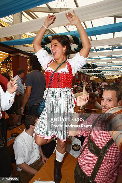 Woman dances on a table at Loewenbrau beer tent at the Oktoberfest beer festival on September 21, 2008 in Munich, Germany.