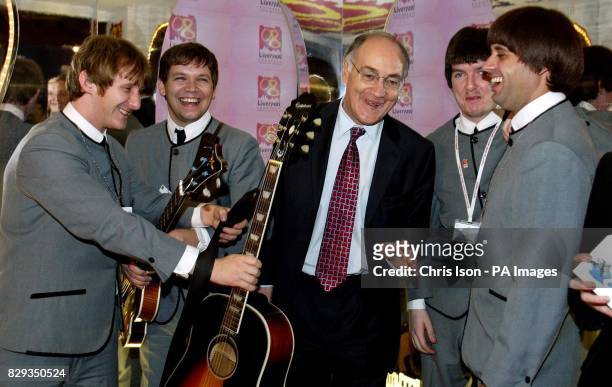 The Conservative Party Leader Michael Howard declines the Mersey Beatles' offer to pose with a guitar on the Liverpool City of Culture stand at the...