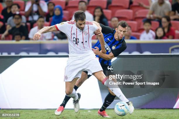 Bayern Munich Midfielder Javi Martinez dribbles FC Internazionale Forward Ivan Perisic during the International Champions Cup match between FC Bayern...