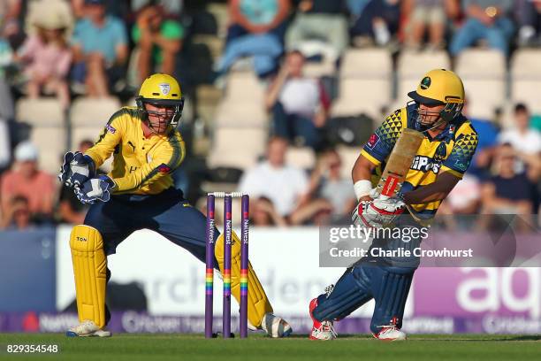 Jacques Rudolph of Glamorgan hits out while wicket keeper Calvin Dickinson of Hampshire looks on during the NatWest T20 Blast match between Hampshire...