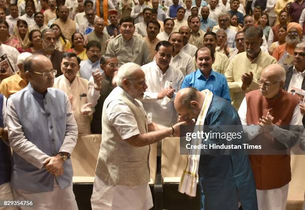 Narendra Modi felicitates BJP President Amit Shah before the start of Parliamentary Meeting during the Monsoon Session at Parliament on August 10,...