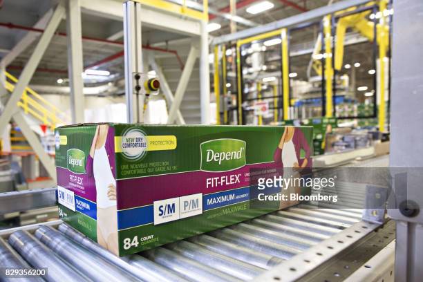 Box of Depend adult diapers moves along a conveyor belt during production at the Kimberly-Clark Corp. Neenah Cold Spring facility in Neenah,...