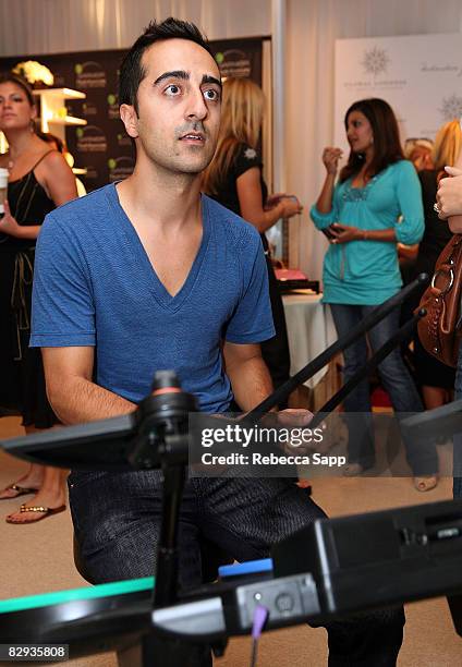 Actor Amir Talai poses with the Activision / RedOctane display during the HBO Luxury Lounge in honor of the 60th annual Primetime Emmy Awards...