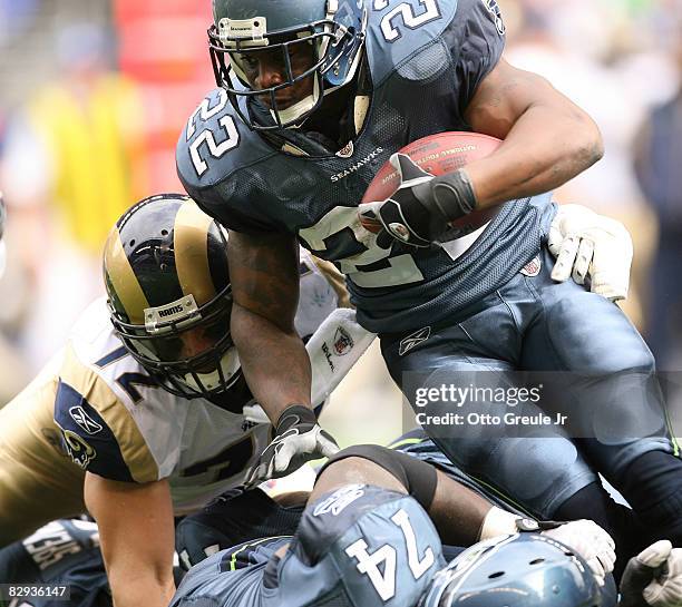 Running back Julius Jones of the Seattle Seahawks rushes against Chris Long of the St. Louis Rams on September 21, 2008 at Qwest Field in Seattle...