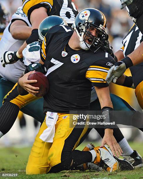 Quarterback Ben Roethlisberger of the Pittsburgh Steelers gets pulled down by his facemask by defensive end Trent Cole of the Philadelphia Eagles on...