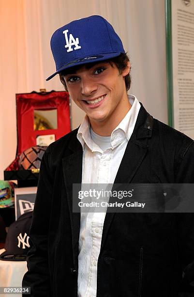 Actor RJ Mitte poses with the New Era Cap display during the HBO Luxury Lounge in honor of the 60th annual Primetime Emmy Awards featuring the In...