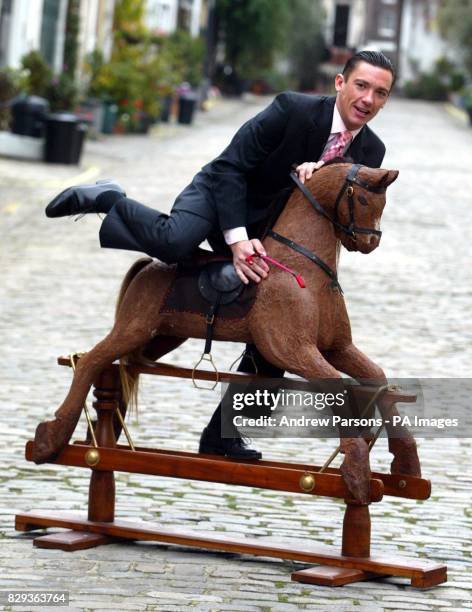 Jockey Frankie Dettori sits on a chocolate horse outside Hyde Park Stables in central London. Dettori, the star of a New Thorntons Christmas...
