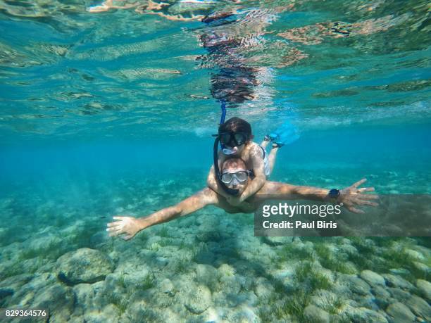 father and son snorkeling in sea, zakynthos island, greece - snorkeling stock pictures, royalty-free photos & images