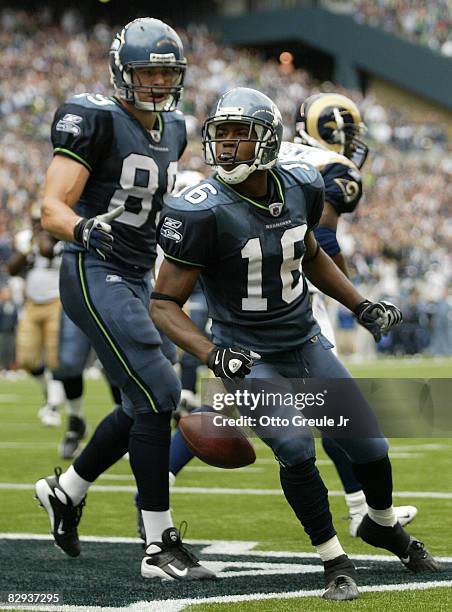 Wide receiver Michael Bumpus of the Seattle Seahawks celebrates with John Carlson after making a touchdown catch against the St. Louis Rams on...
