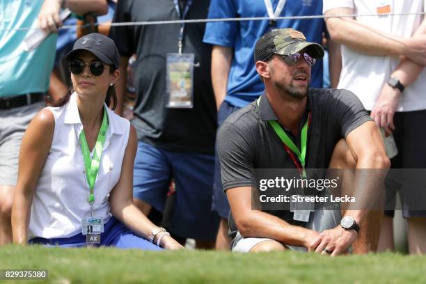 Swimmer Michael Phelps and his wife Nicole Johnson look on during the first round of the 2017 PGA Championship at Quail Hollow Club on August 10,...