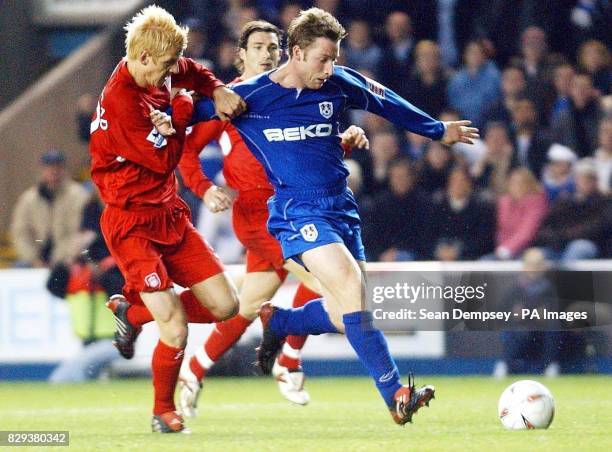 Liverpool's Zak Whitbread tussles with Millwall's Neil Harris during their Carling Cup 3rd round match at the New Den, south London.