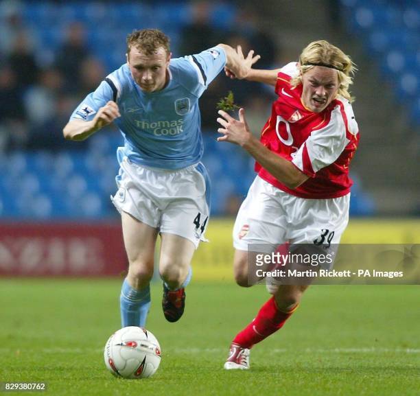 Manchester City's Willo Flood battles with Arsenal's Seb Larsson during the Carling Cup third round match at the City of Manchester Stadium,...