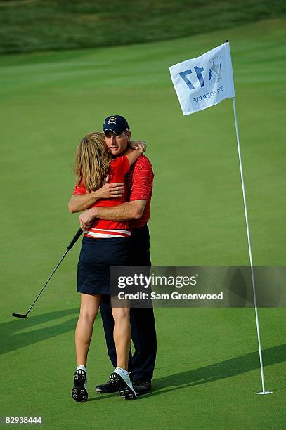Jim Furyk of the USA team celebrates with his wife Tabitha on the 17th green after defeating Miguel Angel Jimenez 2 & 1 to secure the Ryder Cup for...