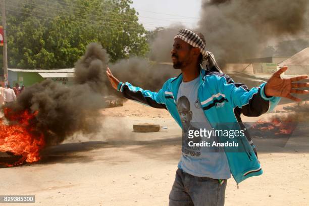 Supporters of the opposition candidate Raila Odinga set fire and block a road during a demonstration against the election results in Garissa, Kenya...
