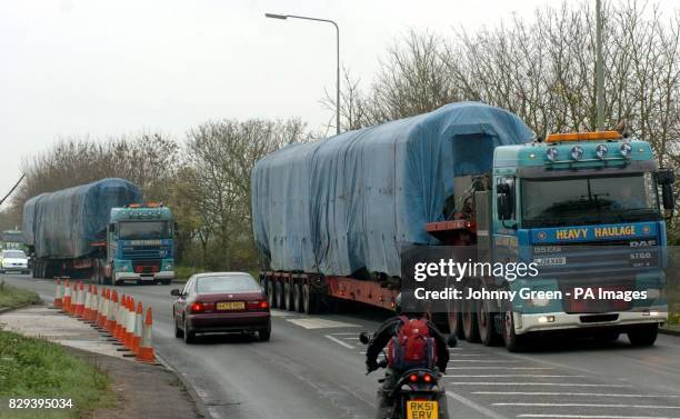 Two lorries carry part of the wreckage from last Saturday's train crash which occurred when a car came to a halt on a level crossing causing the...